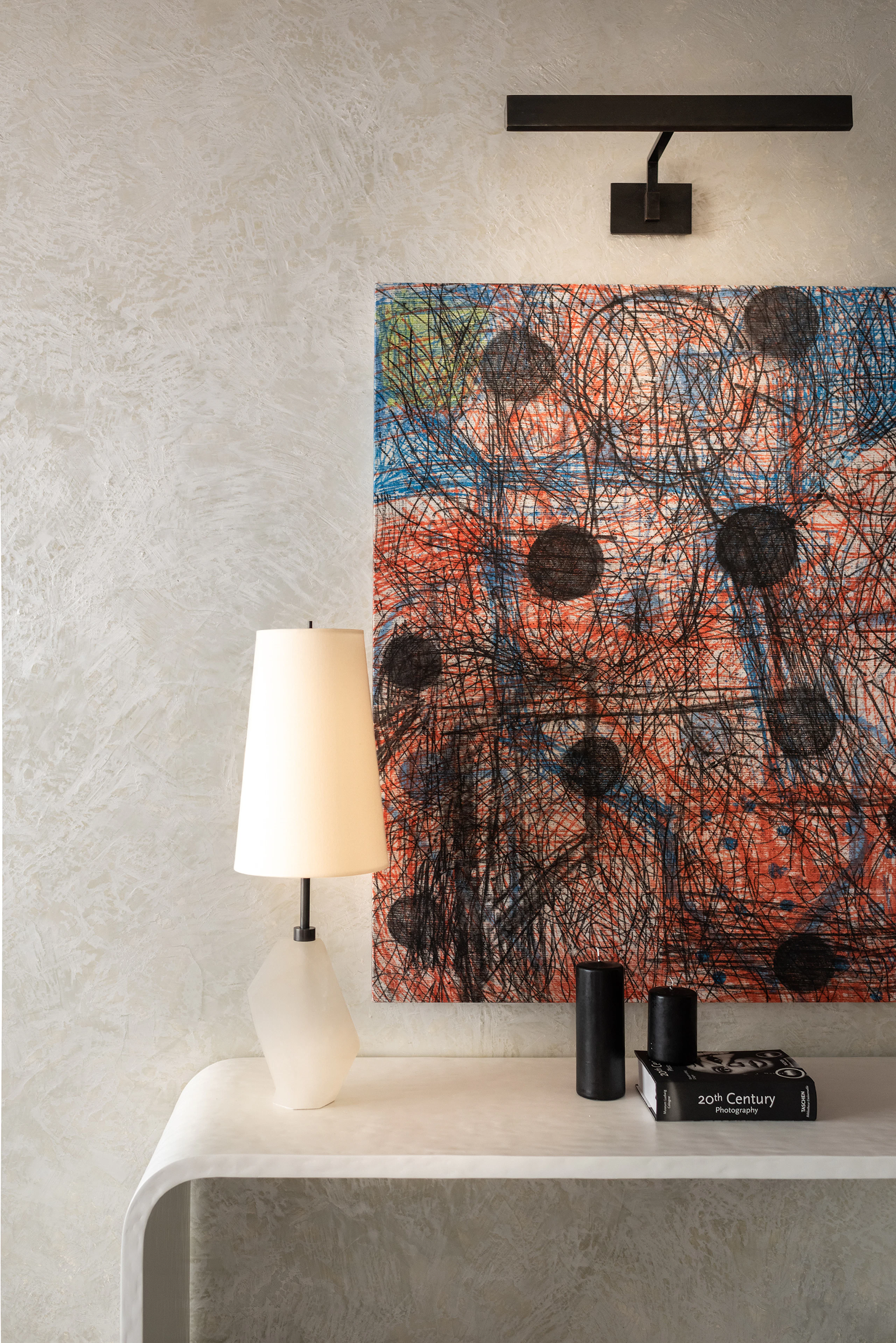 artwork on wall above white console table