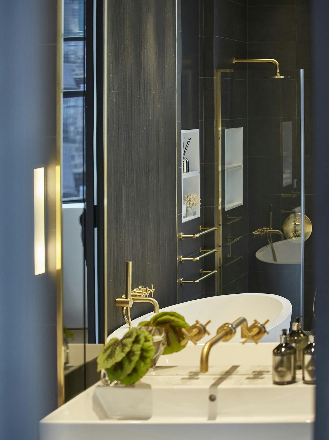 gold wall mounted towel rails and bath taps