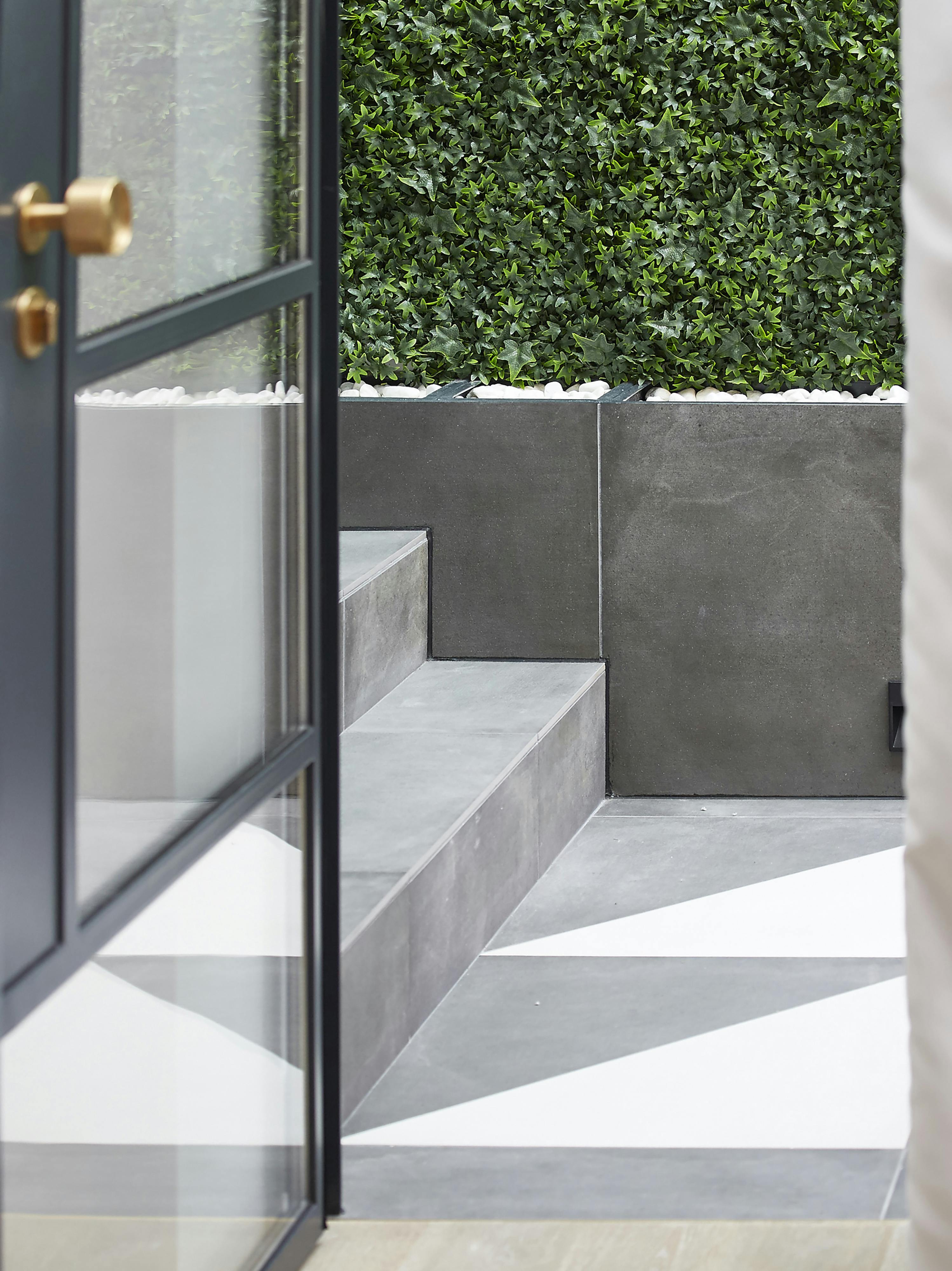 open glass door leading to small winter garden