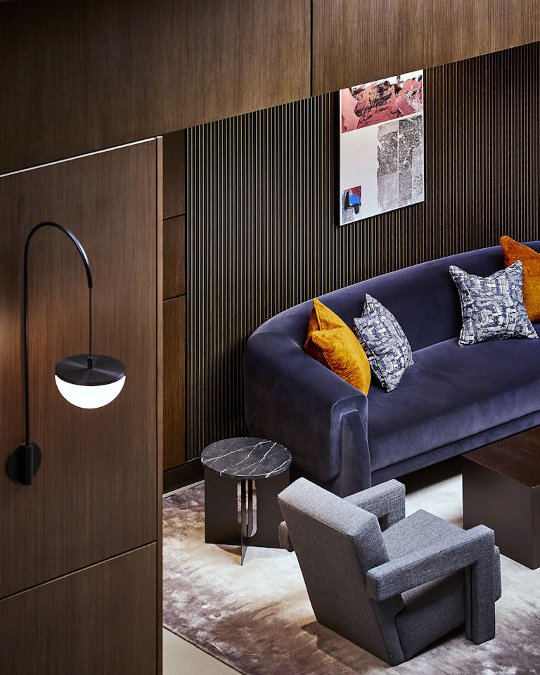mid-century inspiration influences the furniture & lighting on the wall in the atrium